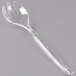 A clear plastic serving fork with a curved edge.