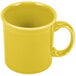 A Fiesta Sunflower china coffee mug with a handle.
