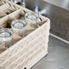 A Vollrath Traex beige full-size glass rack with glasses in it.