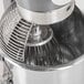 A close up of an Avantco mixer with a wire whisk inside a stainless steel bowl.