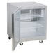 A Traulsen stainless steel undercounter refrigerator with a left hinged door open.