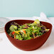 A GET Osslo melamine bowl filled with salad, broccoli, and carrots on a table.