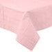 A Classic Pink tablecloth with a white border on a table.