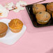 A plate of muffins covered by a Classic Pink Tissue / Poly Table Cover.
