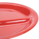 A close up of a red GET Sensation melamine plate with 3 compartments.