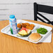 A white polypropylene compartment tray with food and a drink on it.
