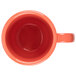 A close up of a GET Rio Orange Tritan mug with a handle.