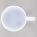 A white GET Tritan mug with a clear liquid inside.