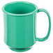 A close-up of a green mug with a handle.