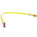 A yellow hose with a silver connector and a white label.