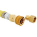 A gold colored T&S gas appliance connector hose with a yellow hose connector.