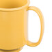 A close-up of a yellow GET Tritan mug with a handle.