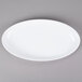 An ivory oval melamine platter with a white rim.