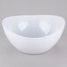 A white GET Osslo melamine bowl with a curved edge on a gray surface.
