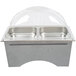 A silver Sterno chafing dish with clear dome covers on a white counter.