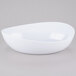 A white Osslo melamine bowl with a curved edge on a gray surface.