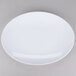 A white Osslo oval melamine platter with a white rim on a gray surface.