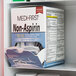 A Medi-First box of non-aspirin acetaminophen tablets on a shelf.