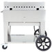 A large stainless steel Crown Verity outdoor griddle with wheels and a black handle.
