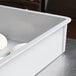A gray MFG Tray fiberglass dough proofing box with trays of dough inside.