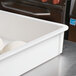 A white fiberglass MFG Tray dough proofing box with dough balls inside.