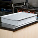 A white fiberglass MFG Tray dough proofing box lid on a white container.