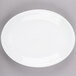 A Libbey bright white porcelain oval coupe platter with a white rim.