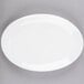 A white oval Libbey porcelain platter with a white rim on a gray surface.