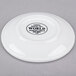 A bright white Libbey Porcelana coupe plate with black text on it.