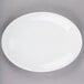 A white Libbey porcelain oval platter with a rolled edge.