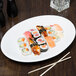 A plate of sushi on a Libbey bright white porcelain oval platter.