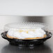 A D&W Fine Pack black pie in a plastic container with a clear dome lid.