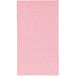 A close-up of a pink paper guest towel with a black border.