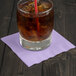 A glass of ice tea with a straw on a Luscious Lavender purple beverage napkin.