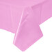 A Creative Converting candy pink plastic tablecloth on a white surface.