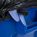 A blue Rubbermaid BRUTE trash can with a black plastic bag around it.