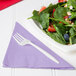 A plate of salad with strawberries, nuts, and a Luscious Lavender 1/4 fold luncheon napkin.
