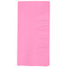 A pink rectangular napkin with a white border.