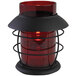 A red candle holder with a black metal base.