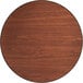 A close up of a Lancaster Table & Seating round wood table top with a brown and wood grain surface.