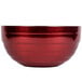 A close-up of a Vollrath Dazzle Red double wall metal bowl.