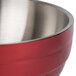 A Dazzle Red Vollrath metal bowl with a stainless steel handle.