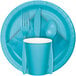A blue plate with a Bermuda Blue 3-ply paper dinner napkin and silverware.