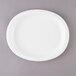 A white oval paper platter on a gray surface.