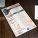 A black Hamilton menu board on a table.