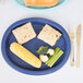 A navy blue oval paper platter with food on it.