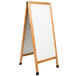 A white porcelain marker board with a wooden frame on an A-frame.