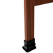 The cherry stained solid oak A-frame of an Aarco sidewalk board with black rubber feet.