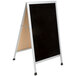 An Aarco aluminum A-frame sidewalk board with a black porcelain marker board and white frame.
