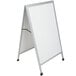 An Aarco aluminum A-Frame sidewalk board with a white porcelain marker board and a silver frame.